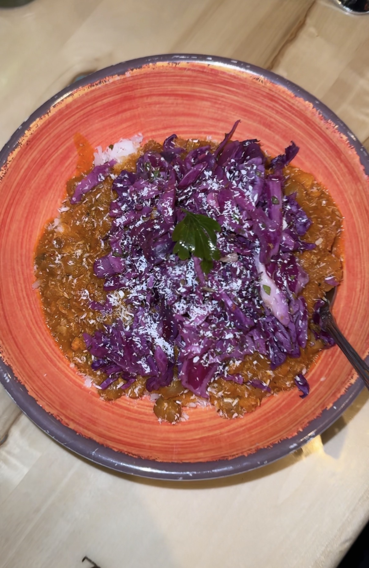 Vegetarian curry bowl with rice, shredded purple cabbage and coconut flakes in a terracotta bowl in Colorado