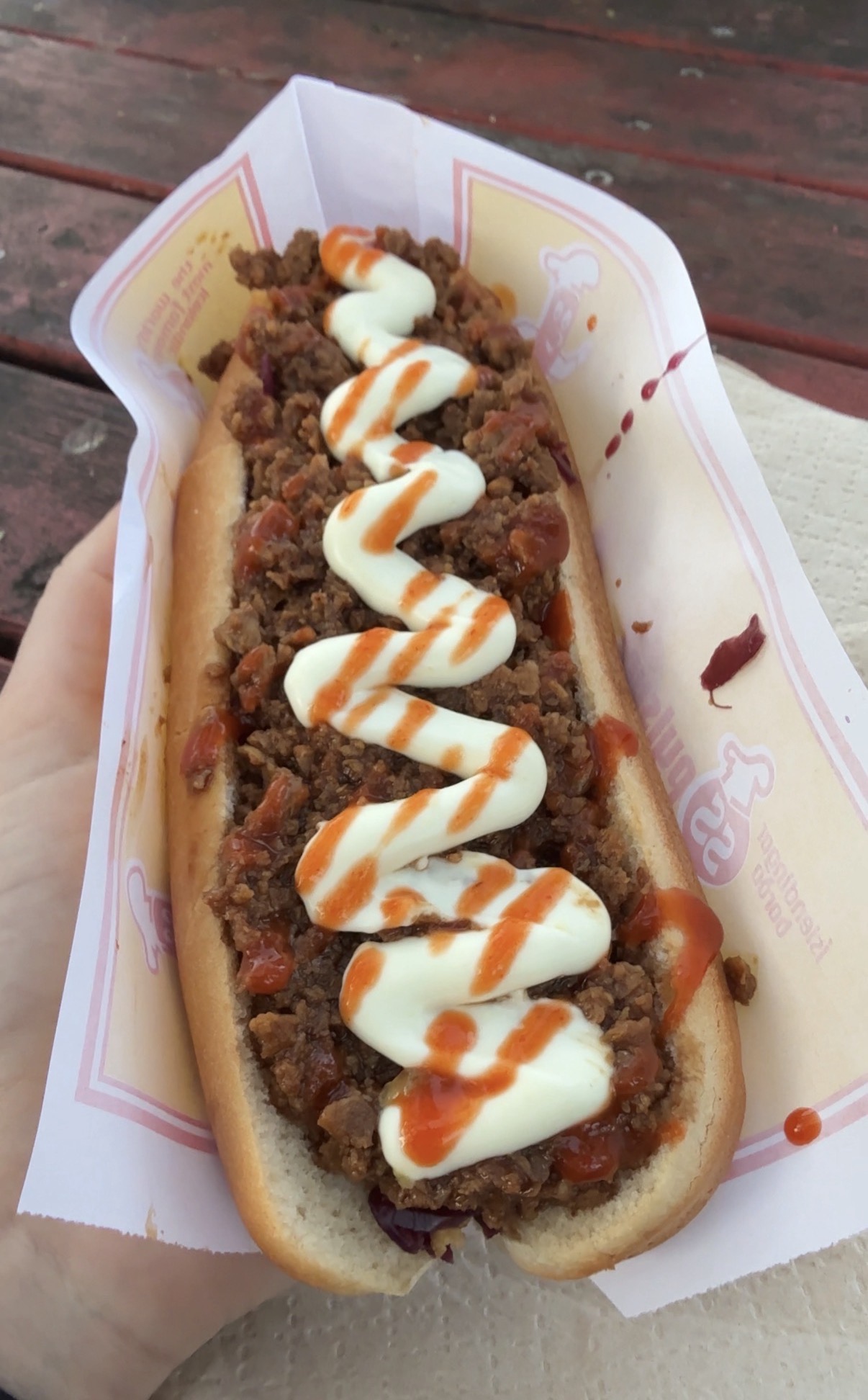 Veggie crumble hot dog topped with mayo and hot sauce in Iceland