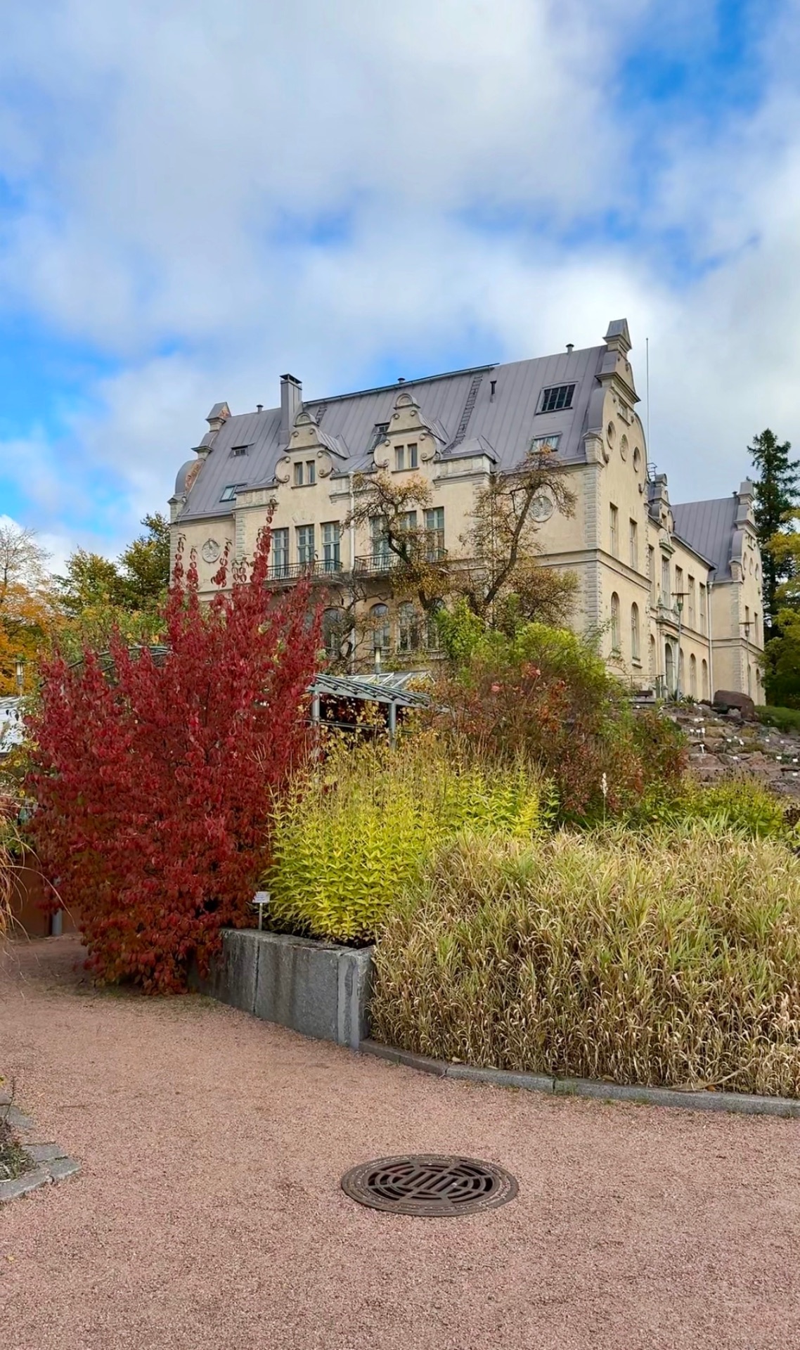 Historic building surrounded by autumn plants in Helsinki