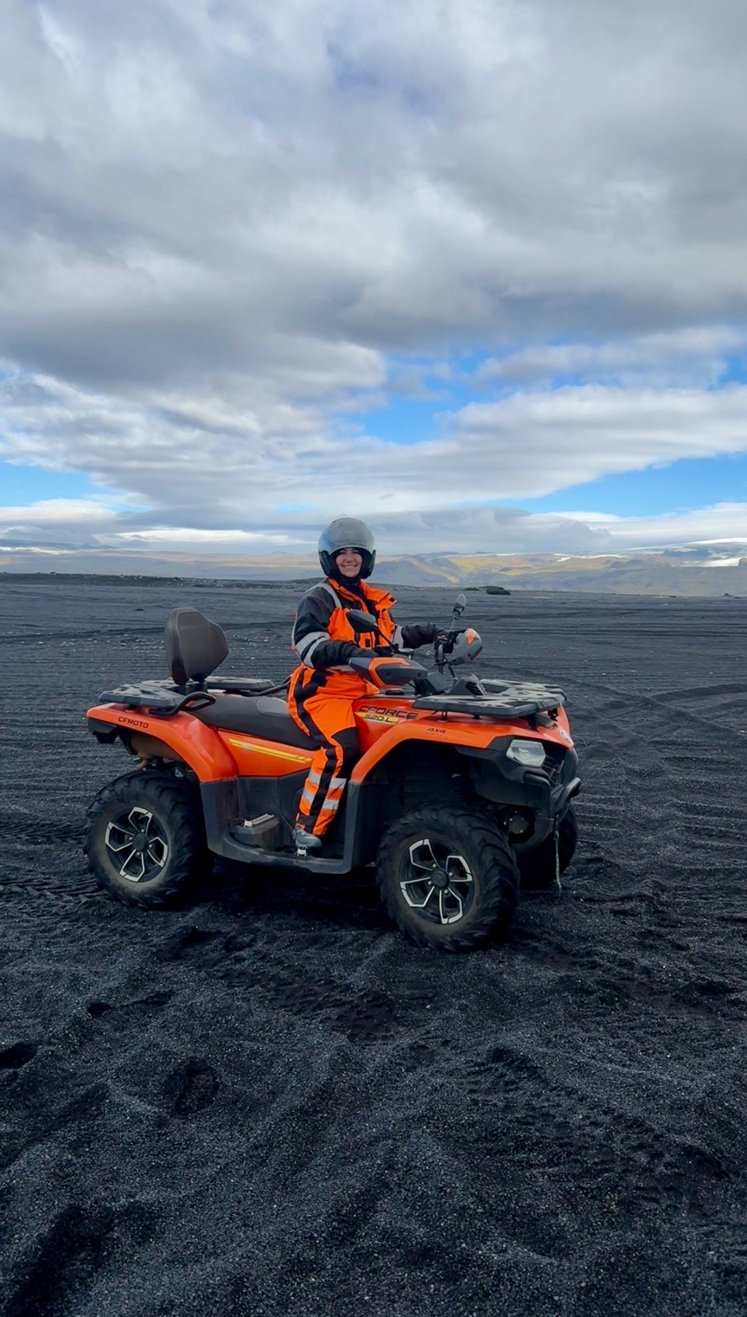 ATV riding across a black sand beach near Vík, Iceland