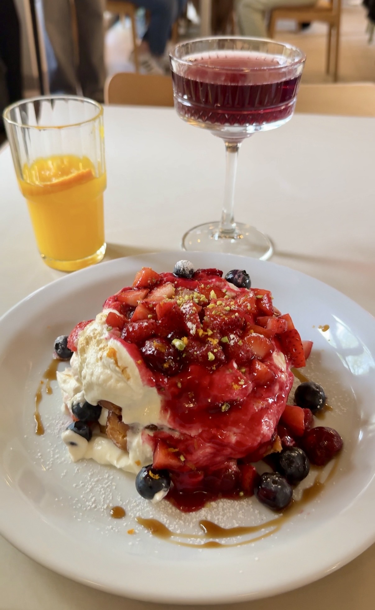 Pancakes topped with strawberries, blueberries and cream at Poranki in Kraków