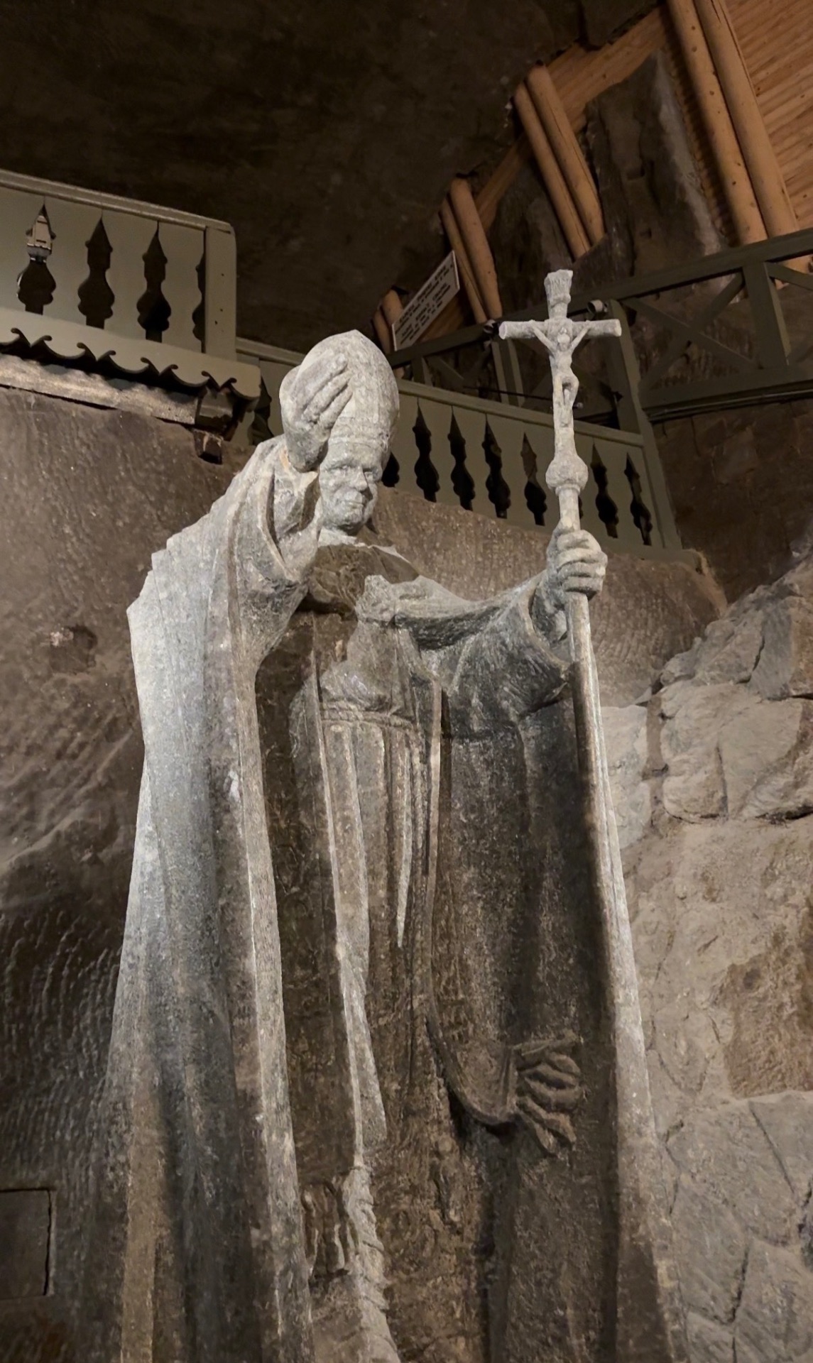 Salt-carved statue of Pope John Paul II blessing with a crozier inside the Wieliczka Salt Mine